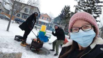 Supplied photo 
(From left) Mungala Londe, youth and families manager, Toryan McCorrister, firekeeper and WE24 and onsite Warming Centre manager Melissa Crait tend the outdoor fire at the Warming Centre, a new initiative of WE24, Spence Neighbourhood Association and the West Central Women’s Resource Centre.