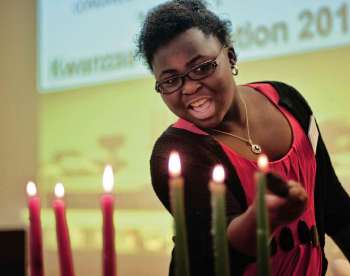 Winnipeg Free Press file photo
Tolu Oladele lights the last candle during a Kwanzaa celebration.