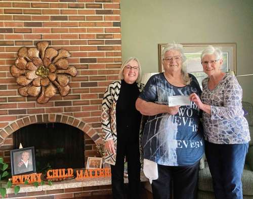 Supplied photo 
Rev. Margaret Mullin of the Place of Hope Indigenous Presbyterian Church accepts a donation from the literacy committee of the Rotary Club of Winnipeg - Assiniboine on behalf of the children in her ministry.