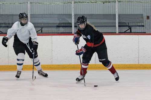 Photo by Katlyn Streilein
Hannah Coukell, 17, (right) is seen handling the puck during a practice at Allard Arena on Dec. 15.