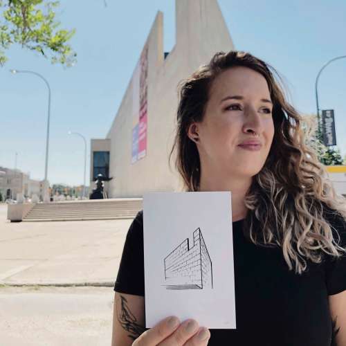 Supplied photo
Local artist Kris Kuzdub is pictured outside the Winnipeg Art Gallery with one of the sketches that’s included in her 2022 calendar.