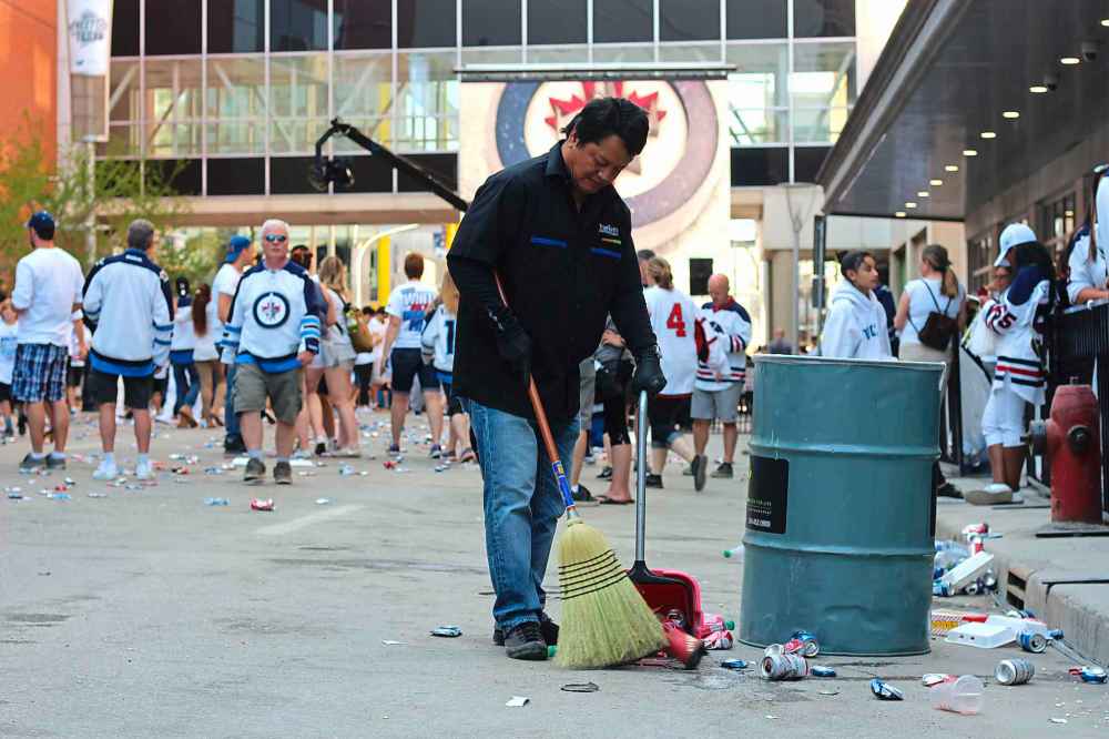 Jessica Botelho-Urbanski/Winnipeg Free Press files
Fans quickly left the Whiteout street party Sunday when the Jets lost on May 20. Romeo Landigha stuck around to clean up the mess.