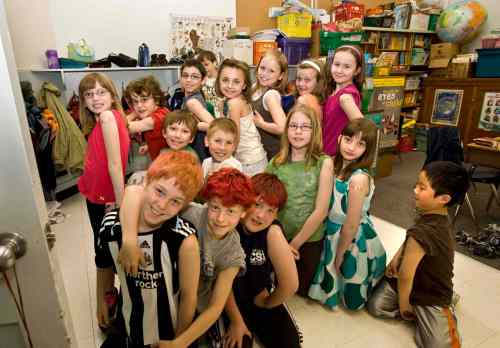 Students at Windsor School show off their bandages after getting their final set of scheduled immunizations by public health nurses in May 2009. (Ruth Bonneville / Winnipeg Free Press)