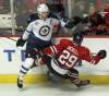 JOE BRYKSA / WINNIPEG FREE PRESS
Winnipeg Jets captain Andrew Ladd, left, send Chicago Blackhawks Bryan Bickell flying in the third period. The Chicago Blackhawks beat the Winnipeg Jets 4-3 Thursday night at the United Centre in Chicago.