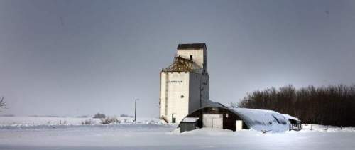 Phil Hossack / Winnipeg Free Press
Clanwilliam's century-old, two-sheet curling rink sits nearly buried in snow in the shadow of a long-abandoned elevator.