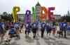 MIKE DEAL / WINNIPEG FREE PRESS
Participants in the pride parade walk along Memorial Boulevard in front of the Manitoba Legislative Building Sunday.