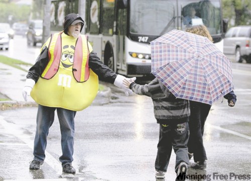 TREVOR HAGAN / WINNIPEG FREE PRESS 
Bob Sweet regularly stops traffic in front of St. Ignatius School with his orange flag and the wacky outfit of the day.