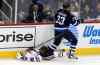 TREVOR HAGAN / WINNIPEG FREE PRESS Chicago Blackhawks' Andrew Shaw (65) is crushed by Winnipeg Jets' Dustin Byfuglien (33) during first period NHL hockey action, Friday, March 18, 2016.
