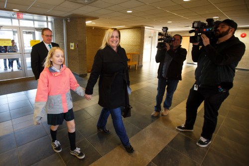 MIKE DEAL / WINNIPEG FREE PRESS
Jenny Motkaluk votes with her husband, Trevor Sprague, and daughter, Emily, 9, at St. Mary's Academy Wednesday morning.