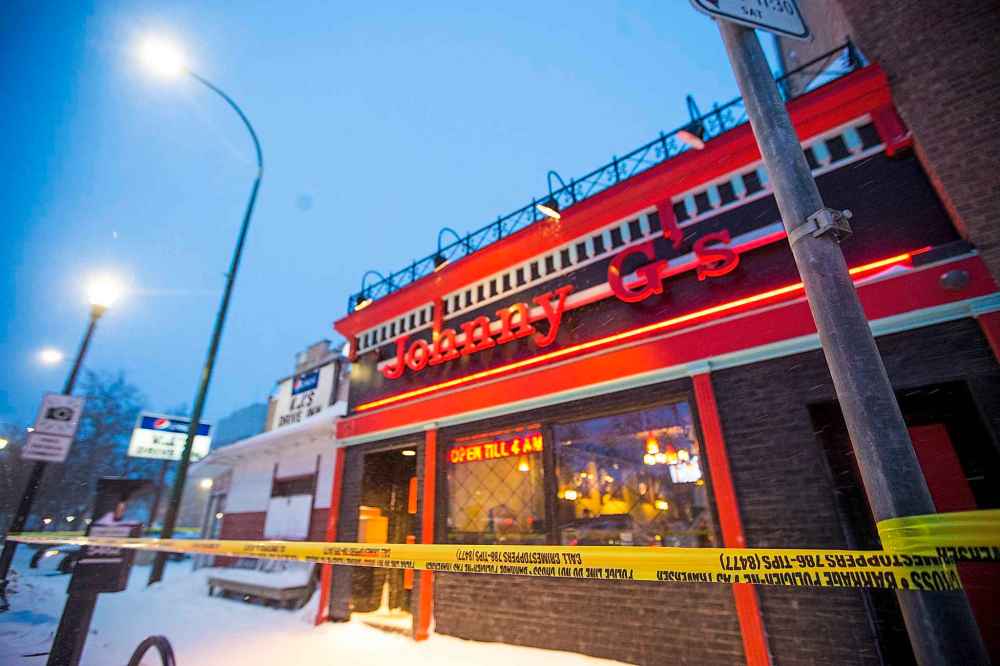 Police tape and cruisers surround Johnny G's Wednesday. (Mikaela MacKenzie / Free Press files)