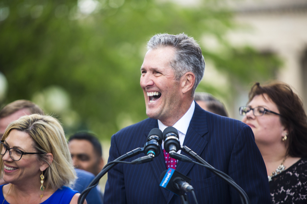 Premier Brian Pallister announces a September election date in front of the Manitoba Legislative Building with his cabinet  in Winnipeg on Wednesday. (Winnipeg Free Press)