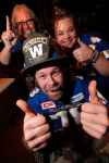 Claudia Byczek (from left), Dan LeBlanc, aka Lt Dan, and Fraser Olson left for Calgary on Tuesday to support the Winnipeg Blue Bombers in the Grey Cup. (John Woods / Winnipeg Free Press)