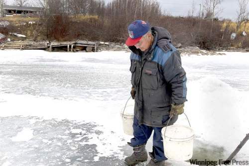 JOE.BRYKSA / WINNIPEG FREE PRESS ARCHIVES
Elder Sam Harper from Wasagamack First Nation retrieves water from Island Lake for his family. More than 1,400 homes on Manitoba reserves have no running water.