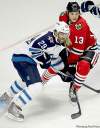 JOE BRYKSA / WINNIPEG FREE PRESS
Winnipeg's Johhny Oduya (left) leans on Chicago's Dan Carcillo.
