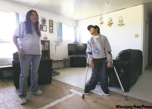 Alice Taylor with her son Kevin,  who has cerebral palsy. She has filed a human rights complaint over the lack of programs for disabled people on the reserve. Below, Kevin Taylor often has to get to the bathroom by crawling.