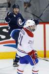 John Woods / The Canadian Press
Winnipeg Jets centre Mark Scheifele celebrates his second goal of the game as the Montreal Canadiens&rsquo; Stefan Matteau skates by during third-period action Saturday. It proved to be the game-winner and Scheifele went on to complerte a hat trick.