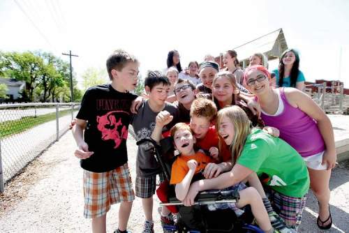 Tyler, 7, is the centre of attention, with sister Emily (right, in green shirt) big brother Griffin (in red) and the class of 2017.