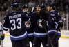 Trevor Hagan / The Canadian Press files
Winnipeg Jets' Dustin Byfuglien (33), Jacob Trouba celebrate after Thorburn scored against the Minnesota Wild during second period NHL hockey action in Winnipeg, Sunday, April 3.