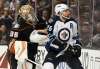 KELVIN KUO / THE ASSOCIATED PRESS
Winnipeg Jets right wing Blake Wheeler, right, knocks the puck up away from Anaheim Ducks goalie John Gibson during the third period in Anaheim, Calif., Tuesday. The Jets won 2-1 in overtime.