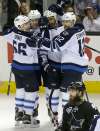JEFF CHIU / THE ASSOCIATED PRESS
Dustin Byfuglien, second from right, celebrates with teammates after scoring against the San Jose Sharks during the third period.