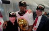 Toronto Raptors center Serge Ibaka, middle, celebrates with Larry Tanenbaum, left, and George Cope after the Raptors defeated the Golden State Warriors in Game 6 of basketball's NBA Finals in Oakland, Calif., Thursday, June 13, 2019. (AP Photo/Tony Avelar)