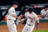 Houston Astros' Alex Bregman hand his bat to first base coach Don Kelly after a home run against the Washington Nationals during the first inning of Game 6 of the baseball World Series Tuesday, Oct. 29, 2019, in Houston. (AP Photo/Eric Gay)