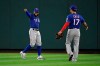 Texas Rangers center fielder Delino DeShields gestures next to right fielder Shin-Soo Choo after making the catch at the wall on a ball hit by Los Angeles Angels' Brian Goodwin during the third inning of a baseball game Wednesday, Aug. 28, 2019, in Anaheim, Calif. (AP Photo/Mark J. Terrill)
