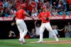 Los Angeles Angels' Kole Calhoun, right, celebrates with Justin Upton (8) after they scored on a double by Albert Pujols during the first inning of a baseball game against the Houston Astros on Tuesday, July 16, 2019, in Anaheim, Calif. (AP Photo/Marcio Jose Sanchez)