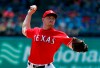 Texas Rangers' Adrian Sampson throws to the Seattle Mariners in the fourth inning of a baseball game in Arlington, Texas, Wednesday, May 22, 2019. (AP Photo/Tony Gutierrez)