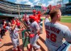 Los Angeles Angels' Luis Rengifo (4) is congratulated in the dugout after hitting a two run home run off of Texas Rangers relief pitcher Phillips Valdez that scored Brian Goodwin during the fifth inning of the first baseball game of a doubleheader Tuesday, Aug. 20, 2019, in Arlington, Texas. (AP Photo/Jeffrey McWhorter)