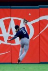 Seattle Mariners center fielder Jake Fraley reaches for but is unable to catch a double by Texas Rangers' Jose Trevino during the third inning of a baseball game in Arlington, Texas, Friday, Aug. 30, 2019. (AP Photo/Tony Gutierrez)