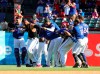 The Texas Rangers rip the jersey off of Nomar Mazara after his sacrifice fly scored Danny Santana for a win over the St. Louis Cardinals in the 10th inning of a baseball game Sunday, May 19, 2019, in Arlington, Texas. (AP Photo/ Richard W. Rodriguez)