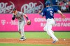 Houston Astros shortstop Alex Bregman (2) reacts after being hit in the face by a ground ball by Texas Rangers' Shin-Soo Choo as Jeff Mathis (2) runs towards second during the third inning of a baseball game Thursday, July 11, 2019, in Arlington, Texas. Bregman left the game because of the injury. (AP Photo/Jeffrey McWhorter)