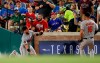 Baltimore Orioles first baseman Trey Mancini (16) watches as right fielder DJ Stewart, left, falls awkwardly while attempting to catch a foul ball hit by Texas Rangers' Elvis Andrus during the sixth inning of a baseball game Wednesday, June 5, 2019, in Arlington, Texas. Stewart left the game. (AP Photo/Brandon Wade)