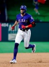 Texas Rangers' Hunter Pence rounds the bases after hitting a two-run home run off Seattle Mariners relief pitcher Ryan Garton in the seventh inning of a baseball game in Arlington, Texas, Monday, May 20, 2019. The shot also scored Nomar Mazara. (AP Photo/Tony Gutierrez)