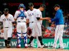 From left to right, Texas Rangers' Rougned Odor, Isiah Kiner-Falefa (9) and Ronald Guzman stand on the mound as starting pitcher Ariel Jurado hands the ball to manager Chris Woodward in the fifth inning of a baseball game against the St. Louis Cardinals in Arlington, Texas, Saturday, May 18, 2019. (AP Photo/Tony Gutierrez)
