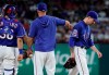 Texas Rangers catcher Jose Trevino, left, stands on the mound as manager Chris Woodward, center, pats the back of starting pitcher Joe Palumbo who walks off the mound in the fourth inning of a baseball game against the New York Yankees in Arlington, Texas, Friday, Sept. 27, 2019. (AP Photo/Tony Gutierrez)