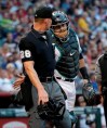 Arizona Diamondbacks catcher Alex Avila interacts with home plate umpire Jim Wolf as Wolf leaves the game after being hit by a foul ball off the bat of New York Mets' Todd Frazier during the second inning of a baseball game, Friday, May 31, 2019, in Phoenix. (AP Photo/Matt York)