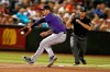 Colorado Rockies third baseman Nolan Arenado tries to field a ball hit by Arizona Diamondbacks' Adam Jones during the sixth inning during a baseball game, Tuesday, Aug. 20, 2019, in Phoenix. Jones reached on an error by Arenado. (AP Photo/Rick Scuteri)