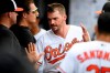 Baltimore Orioles' Trey Mancini reacts in the dugout after he scored on a bases-loaded walk to teammate Chance Sisco during the fifth inning of a baseball game against the Toronto Blue Jays, Sunday, Aug. 4, 2019, in Baltimore. (AP Photo/Nick Wass)
