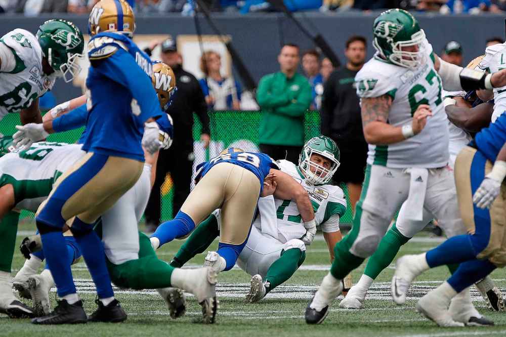 CP
Saskatchewan Roughriders quarterback Zach Collaros (17) gets hit by Winnipeg Blue Bombers' Jeff Hecht (29) during second half CFL action in the 15th annual Banjo Bowl in Winnipeg Saturday, September 8, 2018. THE CANADIAN PRESS/John Woods