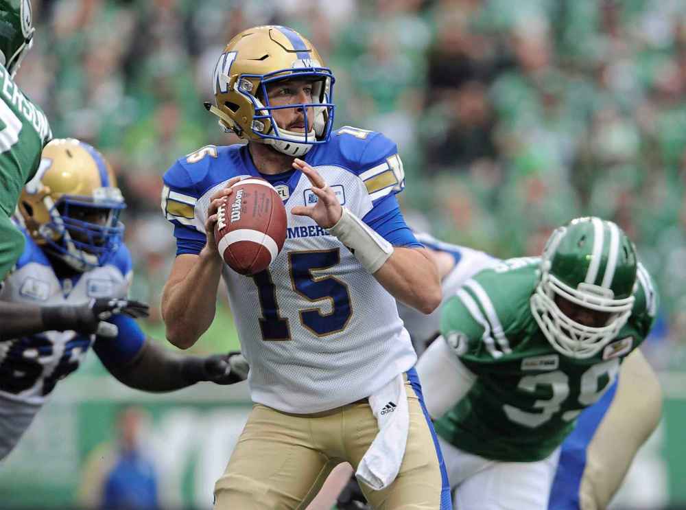 CP
Winnipeg Blue Bombers quarterback Matt Nichols looks for a receiver as Saskatchewan Roughriders' Charleston Hughes closes in during first half CFL football action at Mosaic Stadium in Regina on Sunday, Sept. 2, 2018. The Winnipeg Blue Bombers are looking to help Nichols out. The receivers say they have to step up as their quarterback goes through a rough stretch. Winnipeg has lost three in a row heading into Saturday's game against Saskatchewan. 7THE CANADIAN PRESS/Mark Taylor