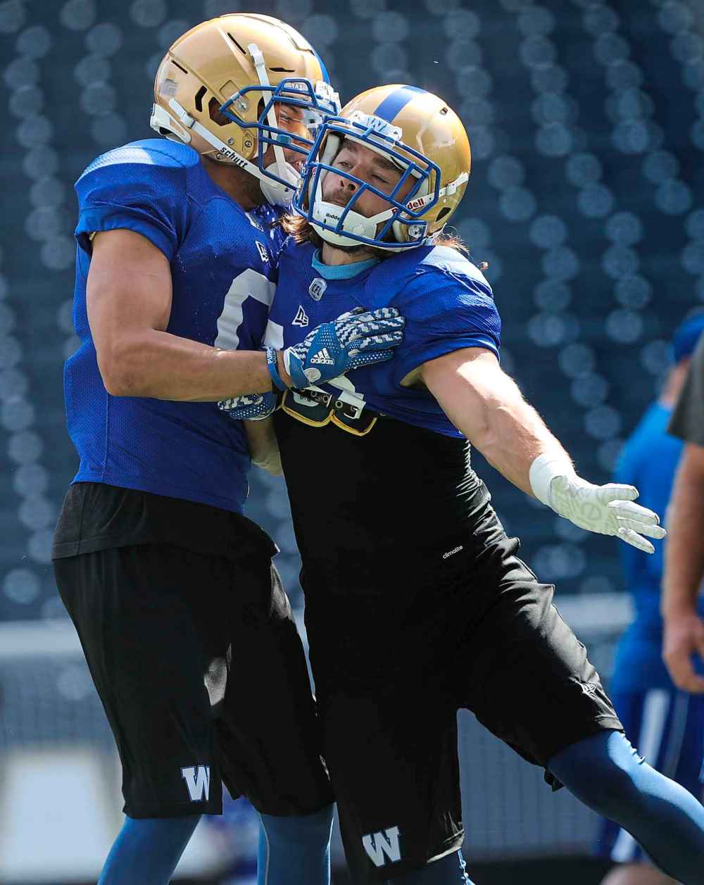 RUTH BONNEVILLE / WINNIPEG FREE PRESS 
Defensive backs Derek Jones, left, and Jeff Hecht have some fun during on-field drills at training camp, Tuesday. Both players are hoping to fill the hole in the Bombers backfield left by all-star safety Taylor Loffler.
