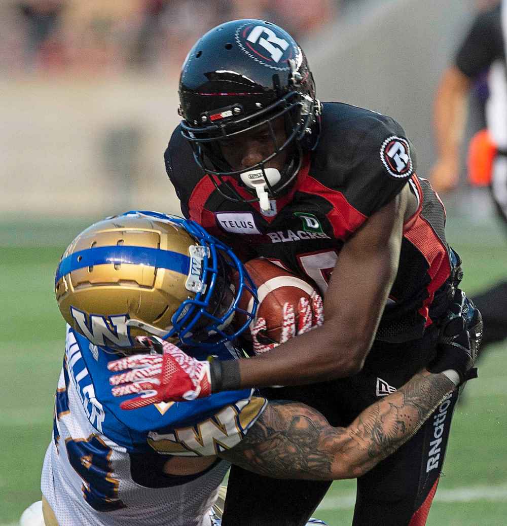 THE CANADIAN PRESS  /Adrian Wyld
Winnipeg Blue Bombers player tackles Ottawa Redblacks wide receiver Ryan Lankford during CFL action in Ottawa, last Friday.