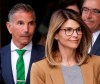 Actress Lori Loughlin, front, and husband, clothing designer Mossimo Giannulli, left, depart federal court in Boston on Wednesday, April 3, 2019, after facing charges in a nationwide college admissions bribery scandal. (AP Photo/Steven Senne)