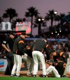 San Francisco Giants pitcher Reyes Moronta, right, is helped to his feet after falling with an injury during the sixth inning of the team's baseball game against the San Diego Padres on Saturday, Aug. 31, 2019, in San Francisco. Moronta left the game. (AP Photo/Ben Margot)