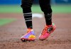 Boston Red Sox's Mookie Betts gets back to first base wearing custom cleats during the second inning of a baseball game against the San Diego Padres, Saturday, Aug. 24, 2019, in San Diego. (AP Photo/Denis Poroy)