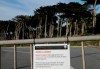 A sign is posted on a gate blocking a parking lot to Land's End in San Francisco, Thursday, Jan. 3, 2019. Nonprofits, businesses and state governments across the country are paying bills and putting in volunteer hours in an uphill battle to keep national parks safe and clean for visitors as the partial U.S. government shutdown lingers. (AP Photo/Jeff Chiu)