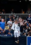 San Diego Padres left fielder Hunter Renfroe jumps onto the outfield padding to try and catch a three-run home run by Pittsburgh Pirates' Josh Bell during the third inning of a baseball game in San Diego, Saturday, May 18, 2019. (AP Photo/Kelvin Kuo)