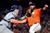 San Francisco Giants' Brandon Belt (9) beats the tag by Los Angeles Dodgers catcher Will Smith, left, on a sacrifice fly by Kevin Pillar during the third inning of a baseball game Friday, Sept. 27, 2019, in San Francisco. (AP Photo/Tony Avelar)